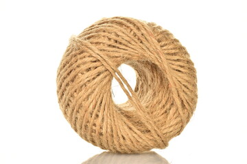 One whole skein of jute thread, close-up, isolated on white.