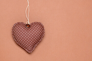 Heart of fabric on a brown background. Time for lovers' day, Valentine's day.