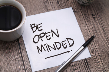 Be Open Minded, text words typography written on paper against wooden background, life and business motivational inspirational