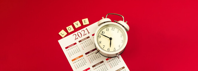 Concept of Valentine's Day banner, red background, love theme with 2021 calendar and alarl clock, time to wake up idea