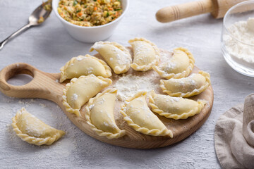 Homemade raw frozen dumplings, vareniki, pierogi, kreplach stuffed with vegan lentil 