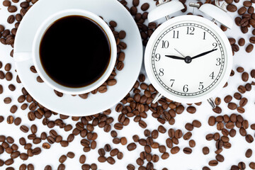 Morning cup of coffee and alarm clock.White background.

