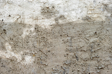 Freshly laid concrete wall with wet patches and scratches background. Stock Photo.