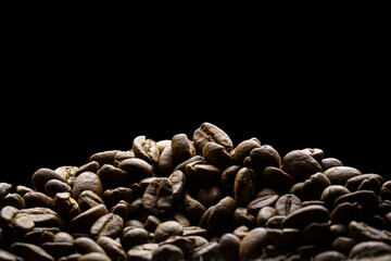 Coffee beans freshly roasted close-up with black background for text space.  - 404532308