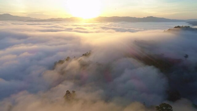 Aerial landscape above the fog with beauty sunlight Golden hour sky Beautiful Sunrise or sunset landscape,Amazing nature Aerial view Misty landscape with Drone flying take a photo nature view
