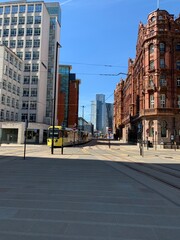 Modern buildings in Manchester City centre with a clear blue sky background. 