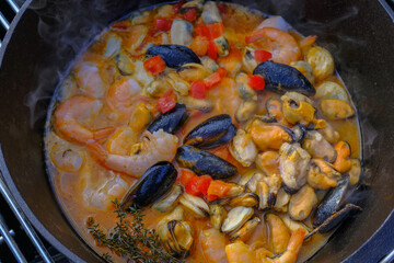 frying pan with seafood and vegetable close-up. Mediterranian cuisine. Spanish traditional meal. 