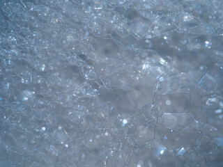 Transparent shiny foam shapes close-up photography abstract background