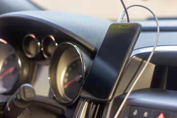 Dashboard with android phone. Magnet holder background blur
