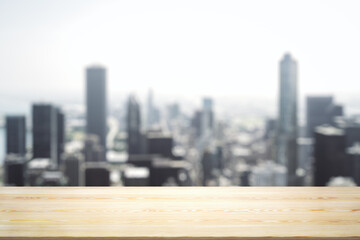 Blank wooden tabletop with beautiful blurry skyline in sunny weather on background, mockup
