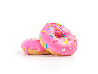 Stack of strawberry flavoured donut with sprinkles on white background. two pink doughnut isolated picture. Homemade bakery concept.