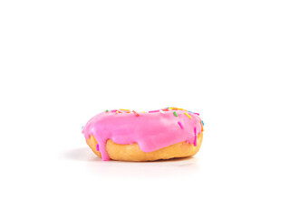Strawberry flavoured donut with sprinkles on white background. One pink doughnut isolated picture. Homemade bakery concept.