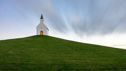 Small white church on a hilltop