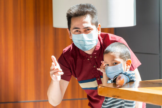 Asian Little Boy With Father Wearing Face Masks For Protect From Coronavirus For Back To School Or Shopping Mall. Father And Child Wear Facemask During Coronavirus And Flu Outbreak. Selective Focus