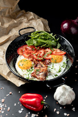 Fried eggs and bacon for breakfast on a plate, top view, 