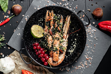 Langoustines. Norway lobster on a black stone background.  Top view.