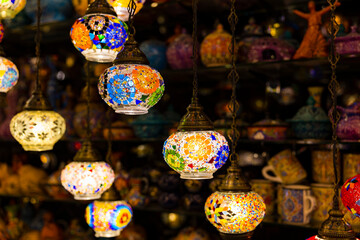 Traditional handmade multicolor Turkish, Moroccan, Arabian lamps hanging with nice blurred background. Mosaic style and colored glass lantern. Suitable for Ramadan Kareem greeting.