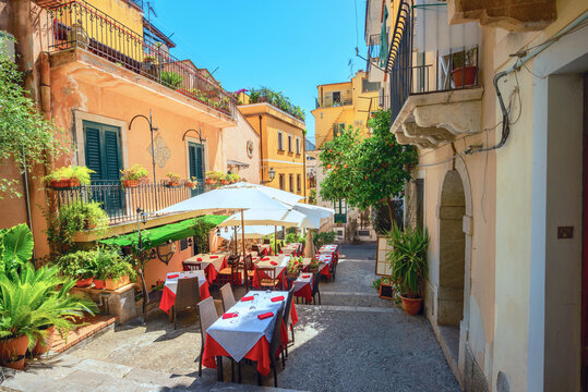 Fototapeta Cityscape with street cafe in old town Taormina. Sicily, Italy