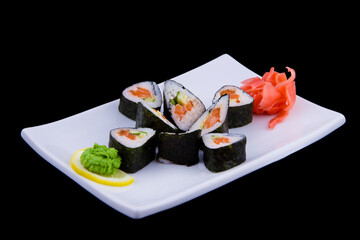 Syake Ikura Maki - Sushi Roll with Fresh Salmon and Cucumber inside on white plate on black background