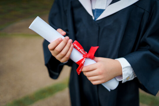 Kids graduation scroll and gown