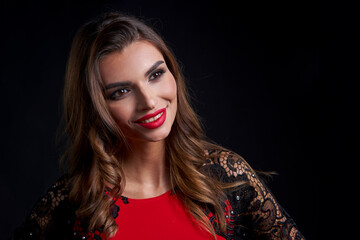 Closeup woman in red dress and red lips makeup looking to side