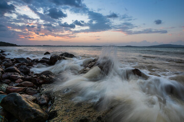 A twilight time after sunset on beach with stone foreground