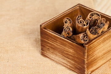 Cinnamomum zeylanicum - Cinnamon stick; photo on wooden background.
