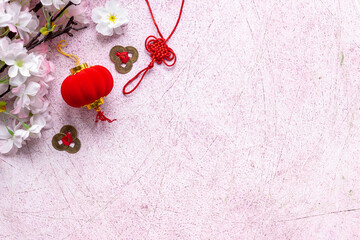 Flat lay of Chinese New Year decoration flowers and red lanterns