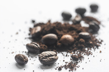 Makro Kaffeebohnen auf Kaffeepulver isoliert auf weiss
