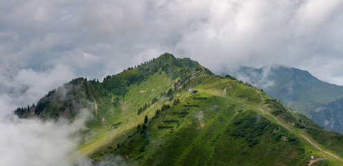 view with the top of mount Muttelbergkopf in Austria among heavy clouds