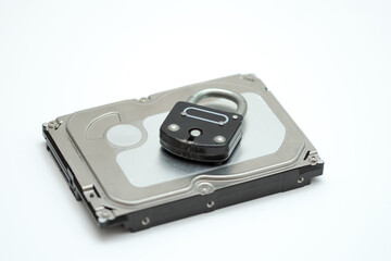 Computer hard disk and metal padlock symbolizing concept for encrypted data, cyber security