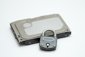 Computer hard disk and metal padlock symbolizing concept for encrypted data, cyber security