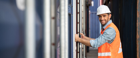 Smart Engineer or supervisor checking and control loading Containers box from Cargo at harbor.Foreman control Industrial Container Cargo freight ship at industry.Transportation and logistic concept.