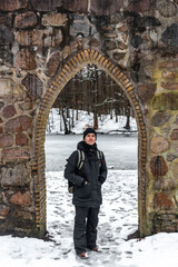 young man in warm clothes enjoying a forest with snow in Denmark