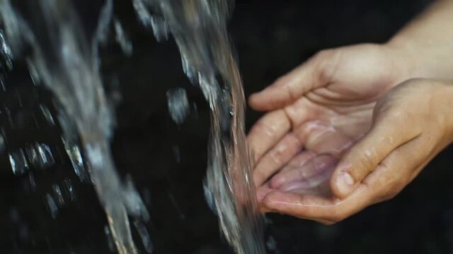 Water pours in man's hands