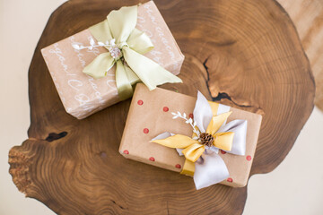 Gift box with ribbon  paper packaging  on a wooden table