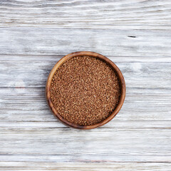 Appetizing buckwheats. Full plate with buckwheats on wooden background with copy space. Healthy eating. Rustic style.