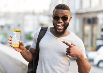 Handsome black guy pointing at smartphone with opened taxi services mobile app