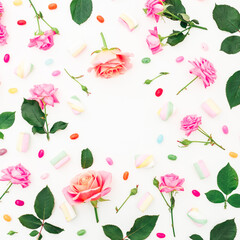 Obraz na płótnie Canvas Roses flowers and marshmallow with candy on white background. Flat lay