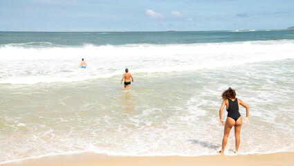   Citizens swim and sunbathe on the beach of Copacabana