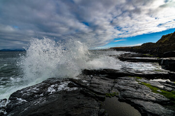 The Atlantic ocean waves crashing in to the cliffs off the west coast of Ireland, County Donegal,  Creavy pier