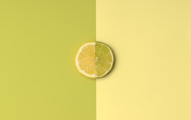 Half Lemon and Lime slice with green and yellow color opposite for spring or summer background. Minimal flatlay concept.