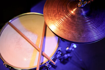 Drum sticks on a snare drum close up top view.
