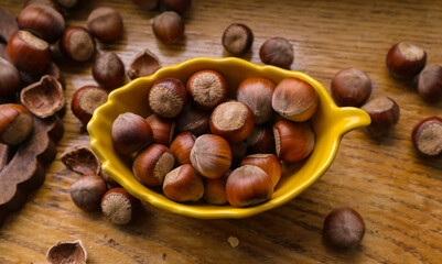 Heap hazelnuts on wooden board wooden background,  selective focus with shallow depth of field
