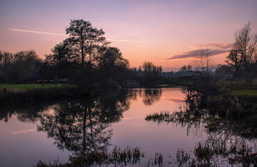 Obraz na płótnie Canvas A winter sunset over the River Stour in Dedham in Essex, UK