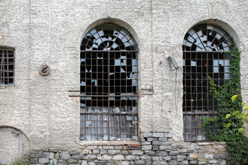 Fototapeta na wymiar windows of an old abandoned factory. Broken glass in an old building