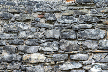 Background and texture of an old stone wall close up