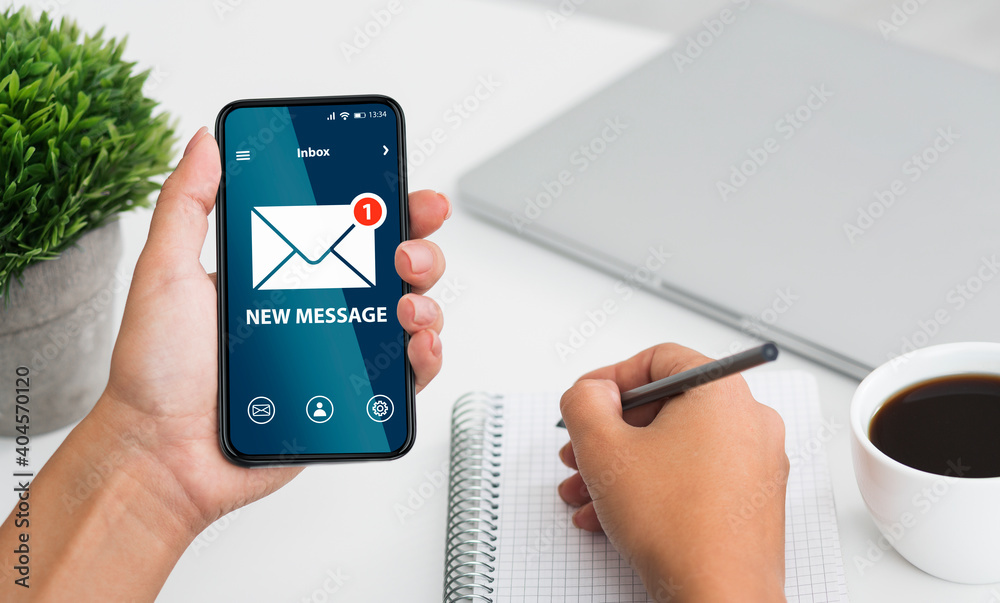 Poster newslettering concept. woman got new message on smartphone while working in office