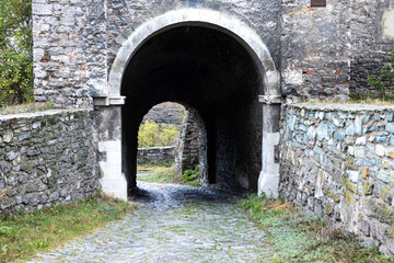 travel arch made of old cobblestone. Castle entrance