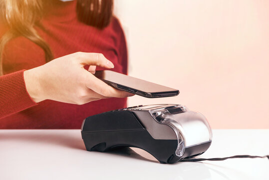 Customer stand near bar counter make payment use credit card close up hands device view, cashless method pay bills in commercial spaces concept